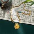 Gold necklace with a pendant on an open book with Chinese text
